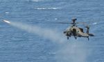 An Army Air Corps Apache attack helicopter launches a Hellfire missile while flying from HMS Ocean. The UK assault carrier is now off Libya. Photo: UK MoD.